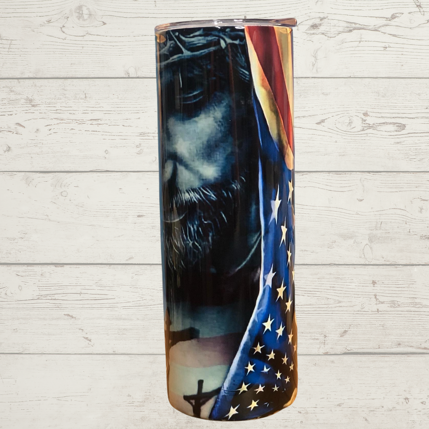 Jesus and American Flag 20 oz Skinny Stainless Steel Sulimation Tumbler Black and White Jesus with a Crown of Thorns Looking down Upon the Crucifixion while Embracing the American Flag Red White and Blue Vivid High Definition Image on a Quality 20 oz Tumbler/Mug/Cup with Lid and Stainless Reusable Straw